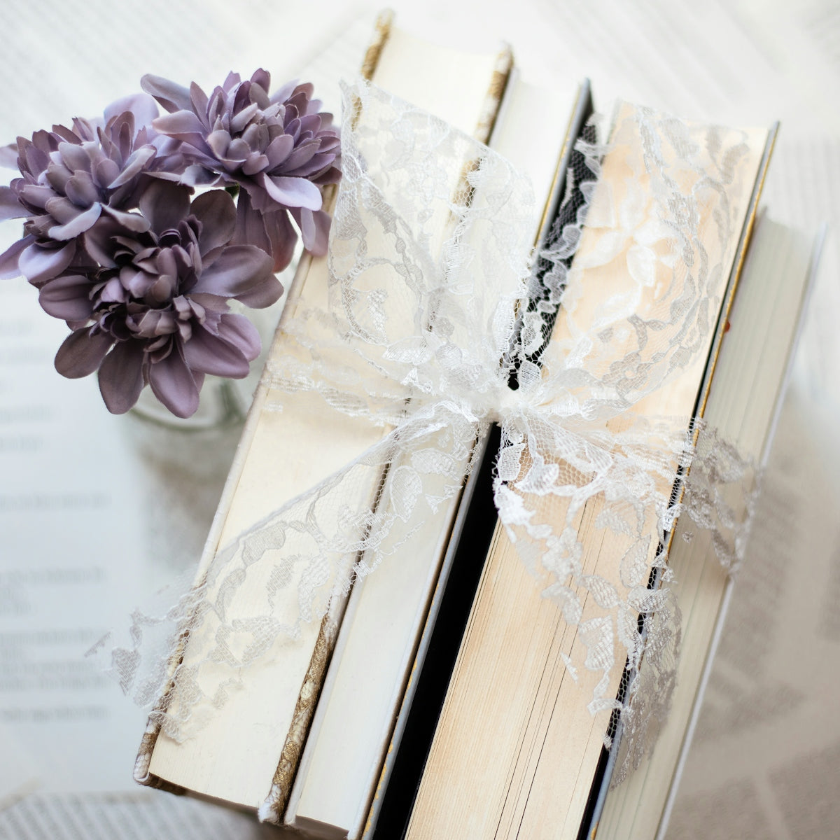 purple petaled flower beside books