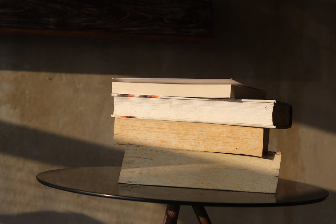 A stack of books sitting on top of a table