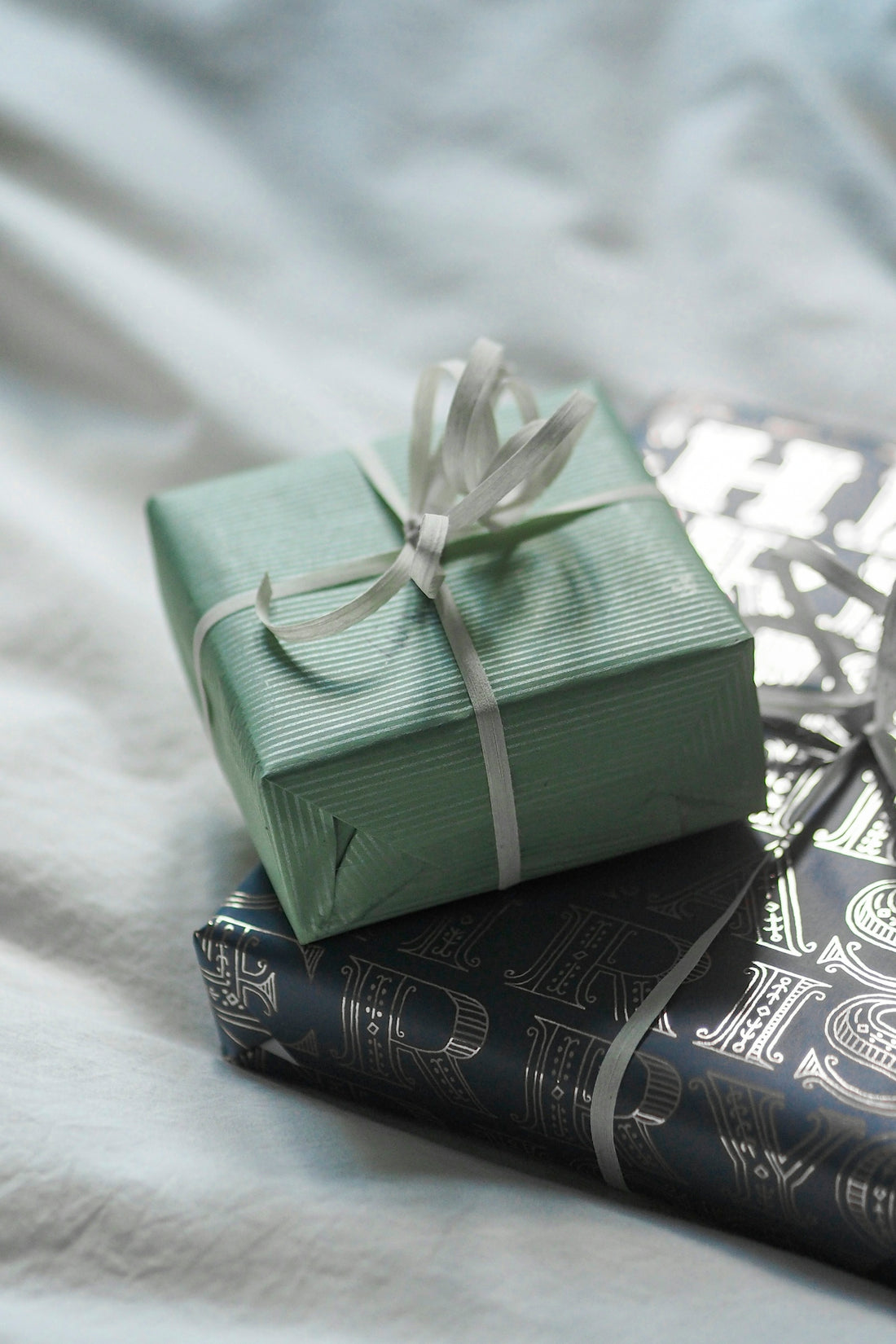 A stack of books with a wrapped present on top of them