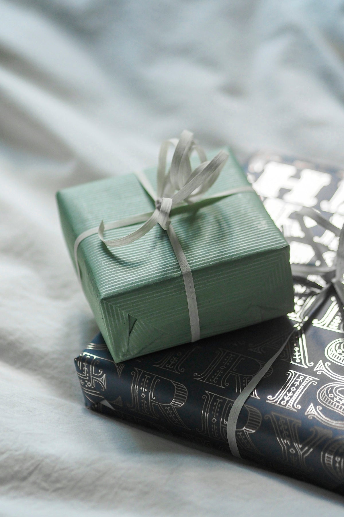 A stack of books with a wrapped present on top of them