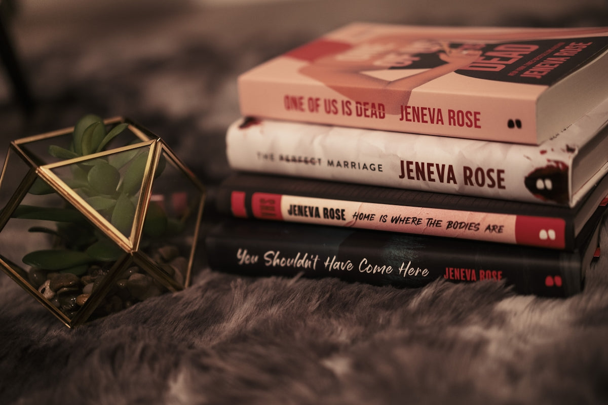 A stack of books sitting on top of a fur covered floor