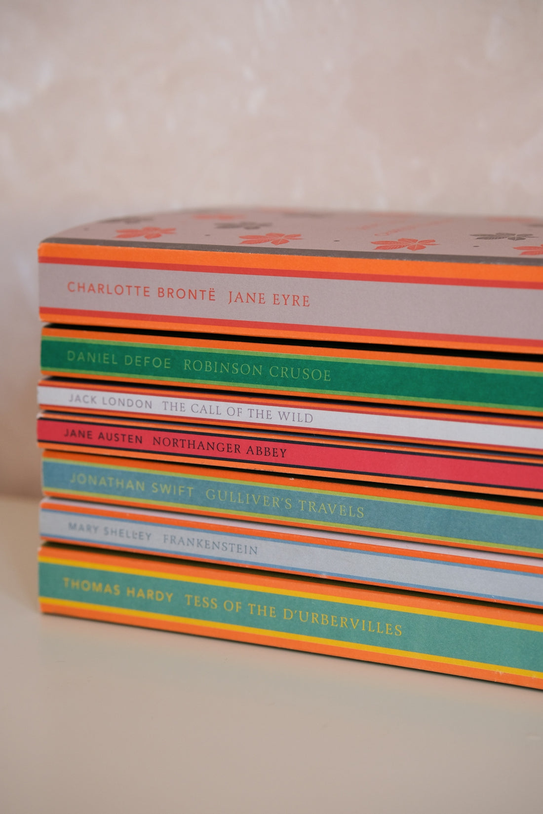 Stack of classic literature books with colorful spines.