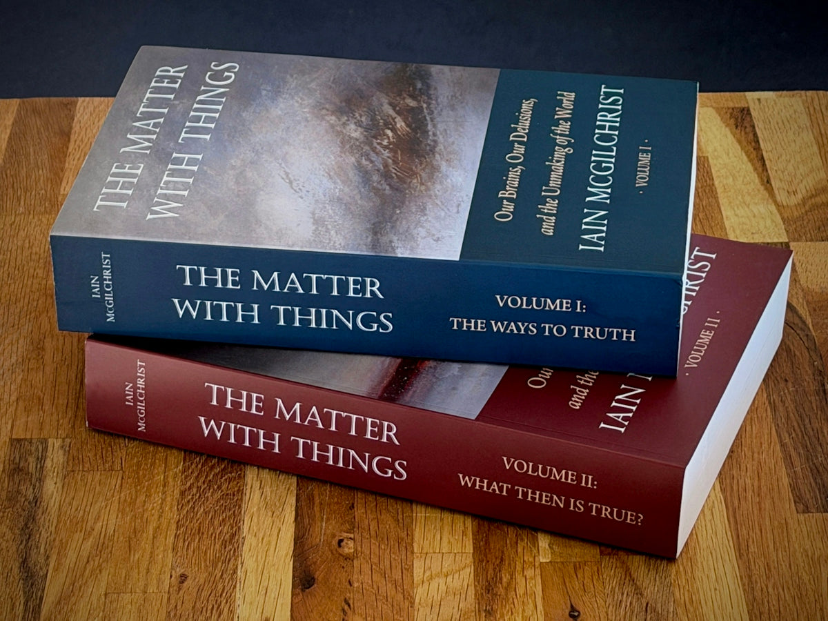 Two volumes of the matter with things books stacked