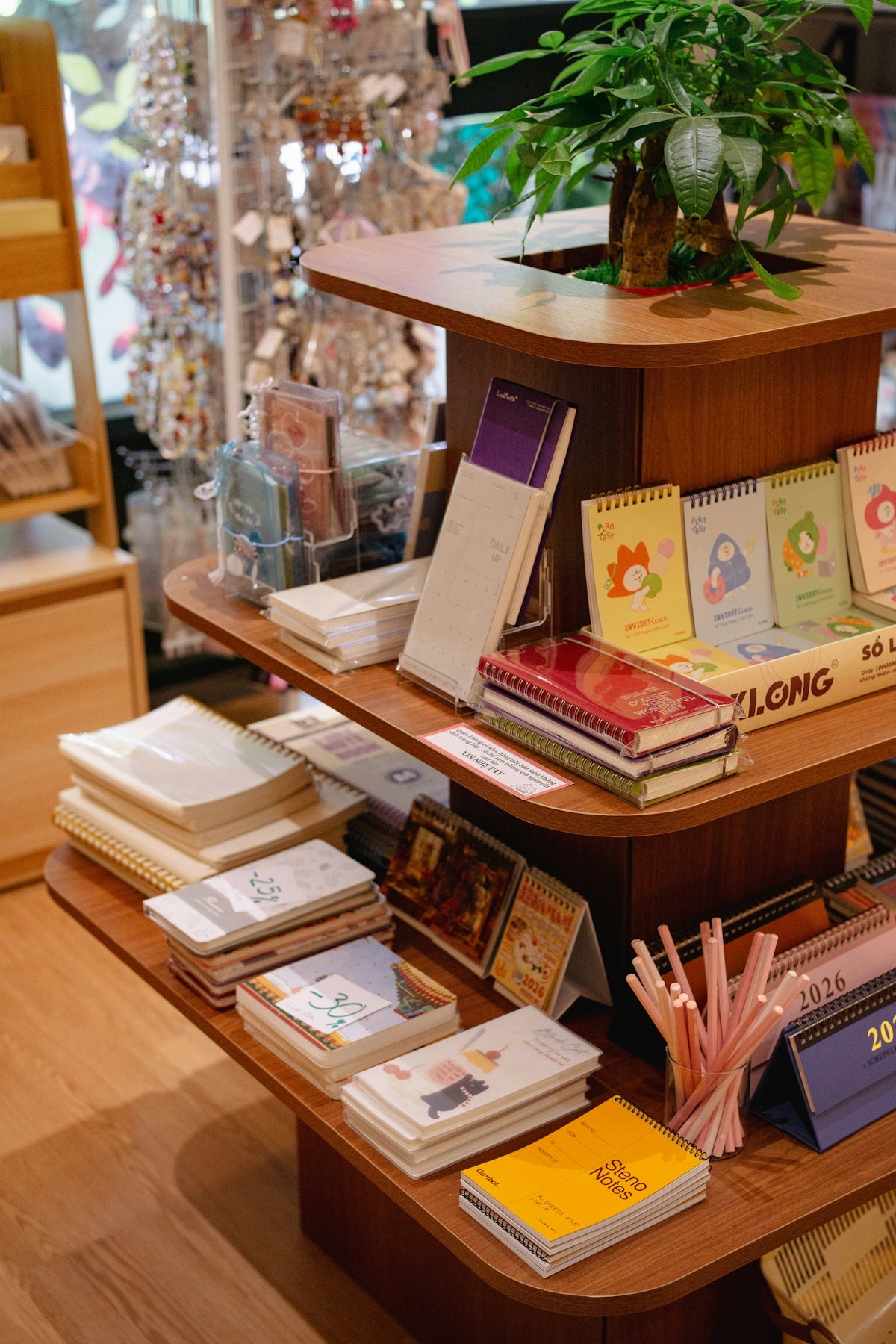 Stationery store shelf displaying notebooks, planners, and office supplies